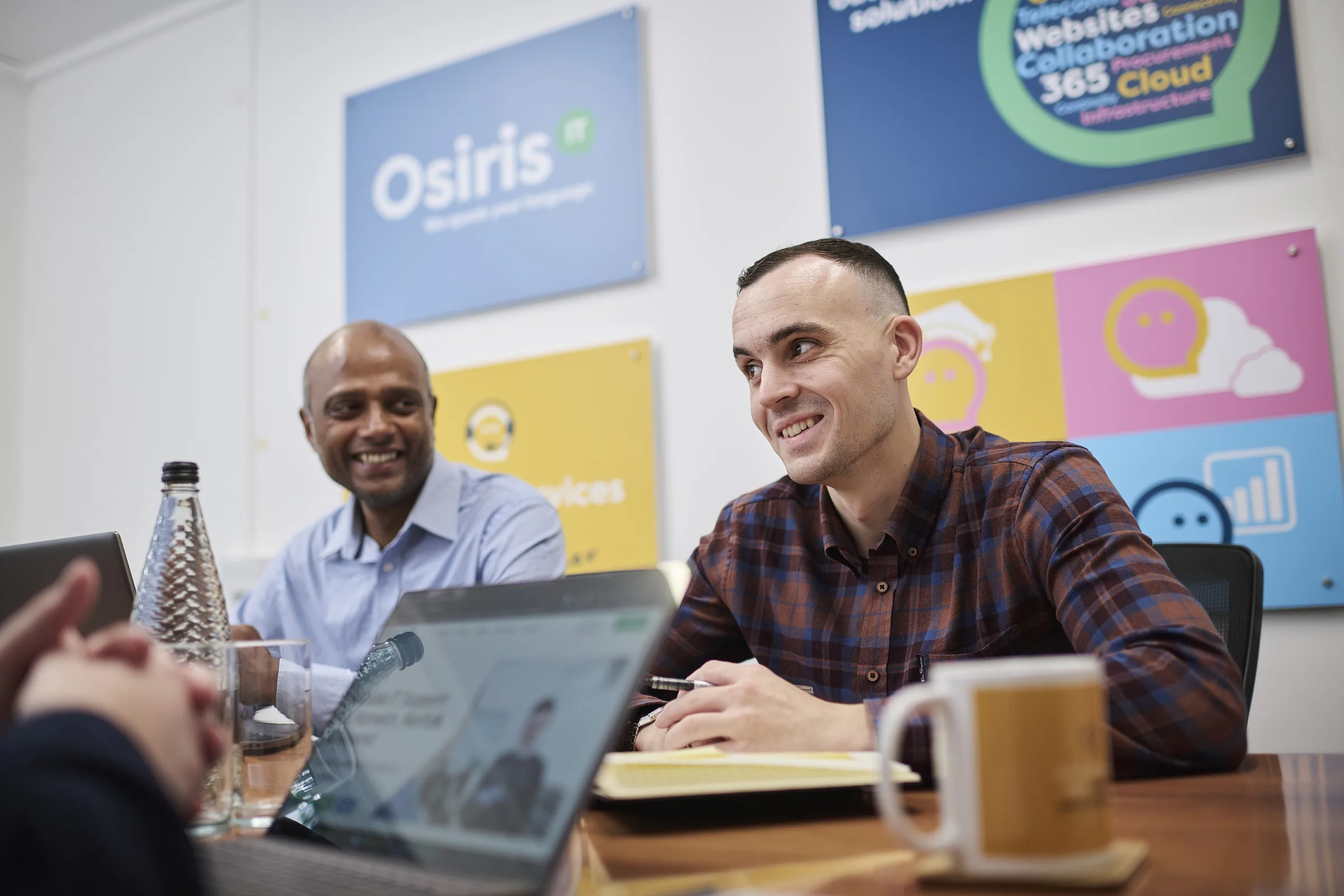 Senior consultants walking finance and operations leaders through a technology strategy in a workshop.